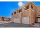 A two-story townhome with a two-car garage in a community, painted in neutral colors with balconies at 1335 E June St # 239, Mesa, AZ 85203