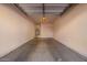 Spacious two car garage with painted walls and concrete floor provides ample storage at 1335 E June St # 239, Mesa, AZ 85203