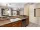 Open kitchen featuring a dual basin sink, tan countertops, dishwasher, and window view to the outside patio at 1335 E June St # 239, Mesa, AZ 85203