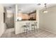 An open kitchen showing a breakfast bar, oak cabinets and stainless steel appliances at 1335 E June St # 239, Mesa, AZ 85203