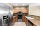 A kitchen with a stainless steel refrigerator and a black electric range and oven at 1335 E June St # 239, Mesa, AZ 85203
