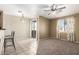 Open living room space featuring both carpet and tile flooring, a ceiling fan and natural lighting at 1335 E June St # 239, Mesa, AZ 85203