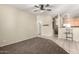Spacious living room with carpet flowing into the tile flooring of the adjacent kitchen and dining areas at 1335 E June St # 239, Mesa, AZ 85203