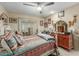 Bedroom with a white metal bed frame, wooden dresser, and southwestern bedding at 13428 N Hawthorn Dr, Sun City, AZ 85351