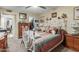 Bedroom with white metal bed frame, wooden dresser, and southwestern bedding at 13428 N Hawthorn Dr, Sun City, AZ 85351