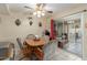 Dining area with wooden table and access to a patio at 13428 N Hawthorn Dr, Sun City, AZ 85351