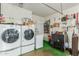Laundry room with washer, dryer, and ample storage at 13428 N Hawthorn Dr, Sun City, AZ 85351