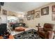 Living room with tiled floors, comfy seating, and gallery wall at 13428 N Hawthorn Dr, Sun City, AZ 85351