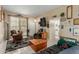 Living room with tiled floors, seating, and access to patio at 13428 N Hawthorn Dr, Sun City, AZ 85351