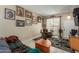 Living room with tiled floors, seating, and access to patio at 13428 N Hawthorn Dr, Sun City, AZ 85351