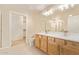 Bathroom with double sink vanity, tile floor, and adjacent walk-in closet at 2121 W Tallgrass Trl # 126, Phoenix, AZ 85085