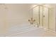 Bright bathroom features a soaking tub next to a glass-enclosed shower at 2121 W Tallgrass Trl # 126, Phoenix, AZ 85085