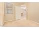 Open bedroom with view to open door, neutral carpet, a ceiling fan and a window at 2121 W Tallgrass Trl # 126, Phoenix, AZ 85085