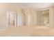 Bedroom with bathroom access and natural light through vertical blinds at 2121 W Tallgrass Trl # 126, Phoenix, AZ 85085