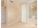Bright bedroom features neutral carpet and sliding glass door at 2121 W Tallgrass Trl # 126, Phoenix, AZ 85085