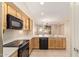 Open kitchen area with wood cabinets and stainless steel appliances at 2121 W Tallgrass Trl # 126, Phoenix, AZ 85085