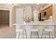 Open-concept design with a breakfast bar that connects to the kitchen, featuring white countertops and light wood cabinets at 2121 W Tallgrass Trl # 126, Phoenix, AZ 85085