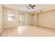 Bright living room featuring tile-look floors, sliding glass door and access to other living spaces at 2121 W Tallgrass Trl # 126, Phoenix, AZ 85085