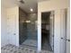 Bathroom with a walk-in shower, patterned tile floor and access to closet at 22874 E Alyssa Rd, Queen Creek, AZ 85142