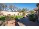 Landscaped backyard with putting green and patio at 2430 W Horsetail Trl, Phoenix, AZ 85085