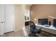 Bright home office features built-in desk and view into bathroom at 2430 W Horsetail Trl, Phoenix, AZ 85085