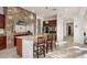 Kitchen island with granite countertop and stone backsplash at 2430 W Horsetail Trl, Phoenix, AZ 85085