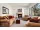 Cozy living room with fireplace, comfortable seating, and natural light at 2430 W Horsetail Trl, Phoenix, AZ 85085