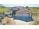Stunning home featuring a spacious three-car garage and desert landscaping at 3701 E Sat Nam Way, Cave Creek, AZ 85331