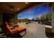 Relaxing patio with fire pit, pool view, and comfortable lounge chairs at 3701 E Sat Nam Way, Cave Creek, AZ 85331