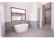 Elegant bathroom with freestanding tub and grey tile at 4411 E Gemini Pl, Chandler, AZ 85249