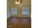 Well-lit bedroom with wood-look floors and dual windows at 7504 W Jenan Dr, Peoria, AZ 85345