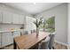 Bright dining area with white cabinets, light wood floors and dining table with seating for four at 9600 N 96Th St # 130, Scottsdale, AZ 85258