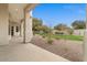 View of a covered patio overlooking a manicured backyard with desert landscaping and grassy area at 2121 N Orchard --, Mesa, AZ 85213