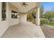 The open-air covered patio is equipped with a ceiling fan and offers views of the backyard at 2121 N Orchard --, Mesa, AZ 85213