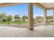 View from the covered patio highlighting desert landscaping and a grassy backyard at 2121 N Orchard --, Mesa, AZ 85213