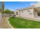 Green backyard with block wall and access gate, offering space for outdoor activities and relaxation at 2121 N Orchard --, Mesa, AZ 85213