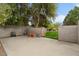 Concrete backyard with trees and privacy wall, offering a functional and secure outdoor area at 2121 N Orchard --, Mesa, AZ 85213