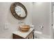 Bathroom features a vessel sink, round mirror, and stylish decor at 2121 N Orchard --, Mesa, AZ 85213