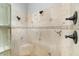 Luxurious shower with travertine tile and bronze fixtures for a spa-like experience at 2121 N Orchard --, Mesa, AZ 85213