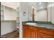 Bathroom with wood cabinet, open closet, and a granite countertop at 2121 N Orchard --, Mesa, AZ 85213