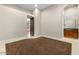 Vacant bedroom featuring carpet floors, baseboards, and a glimpse into the bathroom at 2121 N Orchard --, Mesa, AZ 85213