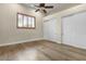 Inviting bedroom featuring hardwood floors and plantation shutters for natural light and privacy at 2121 N Orchard --, Mesa, AZ 85213