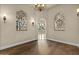 Dining room featuring hardwood floors, decorative lighting, and ornate iron decor at 2121 N Orchard --, Mesa, AZ 85213