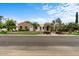 Charming single-story home with lush landscaping, mature trees, and a circular driveway at 2121 N Orchard --, Mesa, AZ 85213