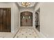 Grand foyer with ornate double doors, decorative tile flooring, and elegant lighting fixtures at 2121 N Orchard --, Mesa, AZ 85213