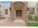 Grand entrance with stone archway and wooden double doors, creating a welcoming and luxurious feel at 2121 N Orchard --, Mesa, AZ 85213