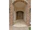 Close-up of the front entrance, highlighting the stone archway and wooden double doors at 2121 N Orchard --, Mesa, AZ 85213