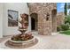 Beautiful entryway with stone accents and a charming fountain, adding elegance and character to the home's exterior at 2121 N Orchard --, Mesa, AZ 85213