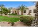 Attractive house exterior boasting lush landscaping, a stone accent wall, and a charming water fountain feature at 2121 N Orchard --, Mesa, AZ 85213