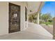 Front entryway featuring an ornate glass door, and a covered patio with ceiling fan at 2121 N Orchard --, Mesa, AZ 85213